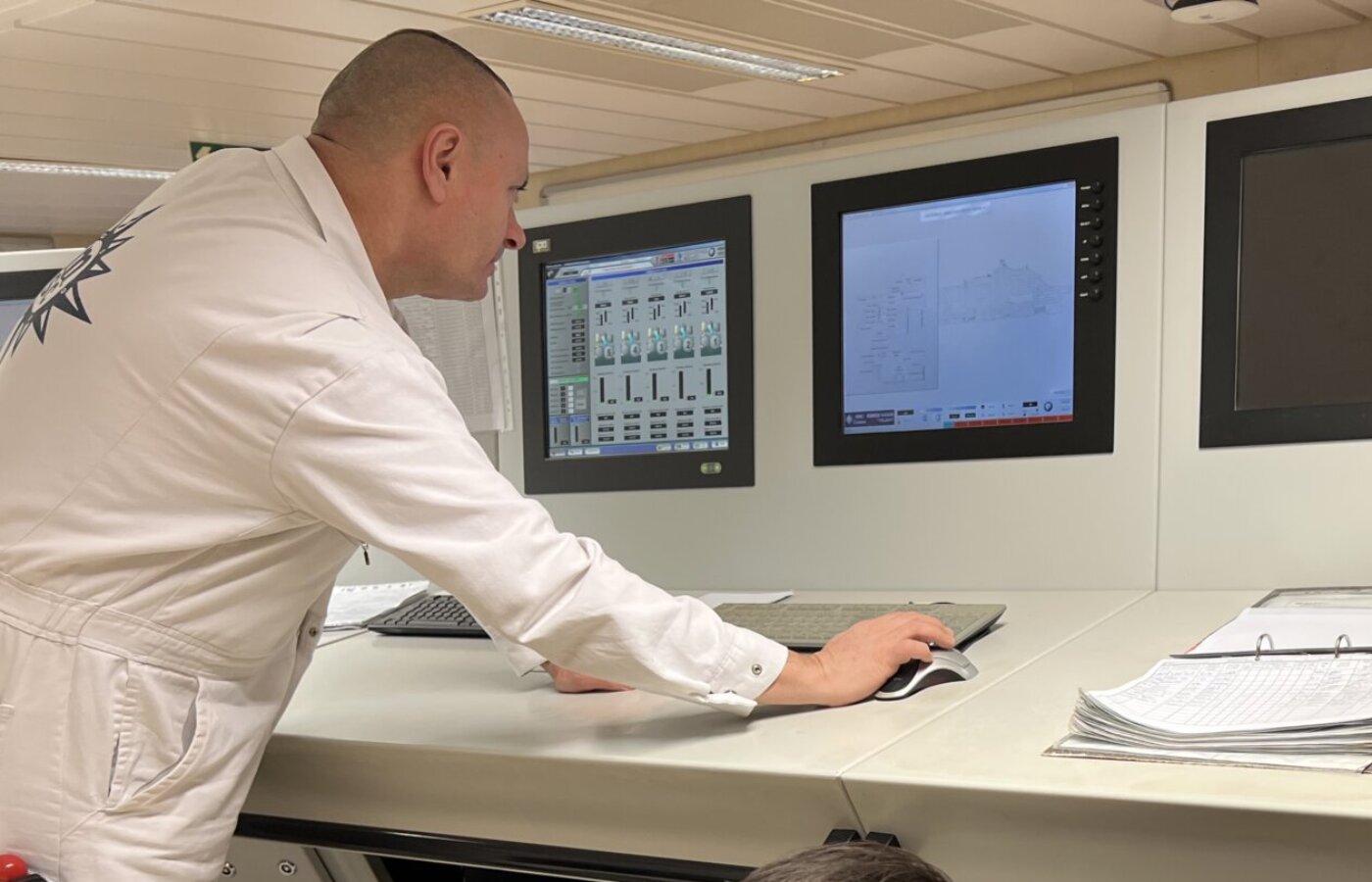 Ship engineer operating HVAC control console on cruise vessel